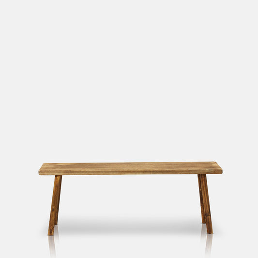 Long natural wooden bench with four legs.