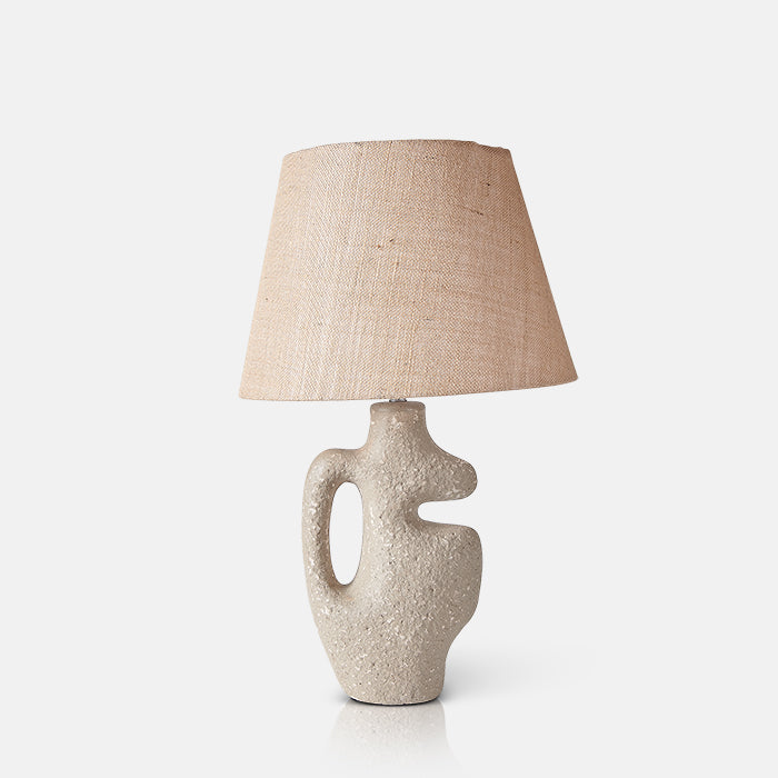 Sculptural ecomix lamp base in natural beige finish, with tapered brown jute shade.