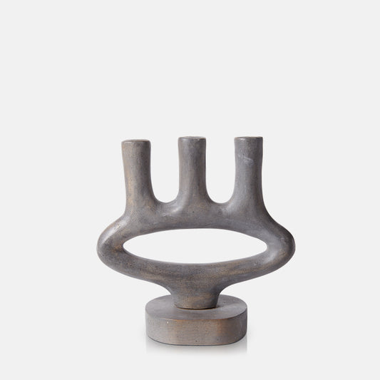 Sculptural stone-look candelabra with three candleholders, finished in rustic brown and grey.