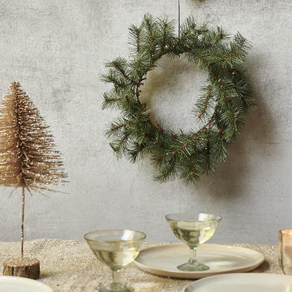 Green Christmas wreath for seasonal decoration.