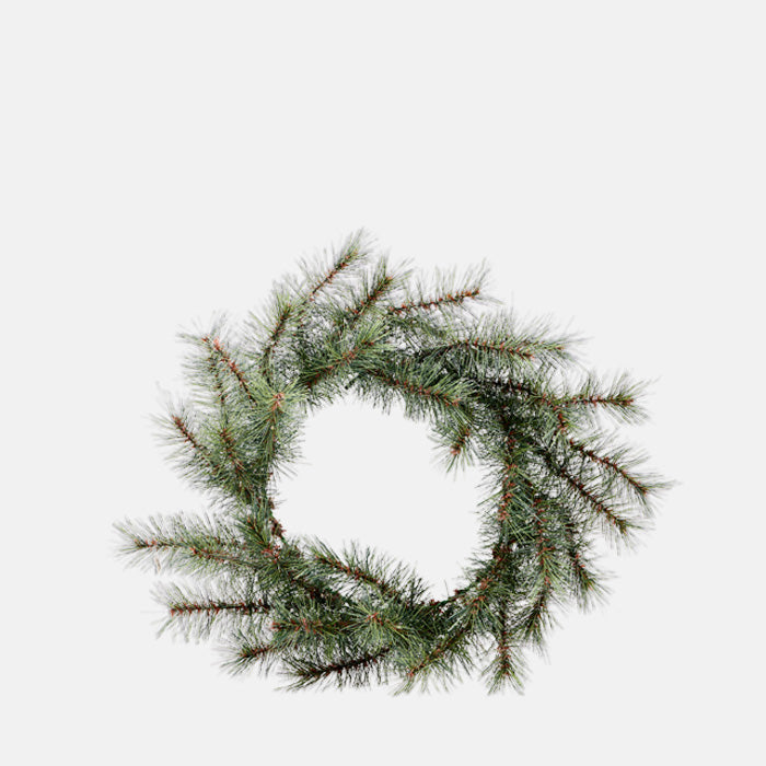 Christmas wreath with short, pine branches entwined in a circular shape.