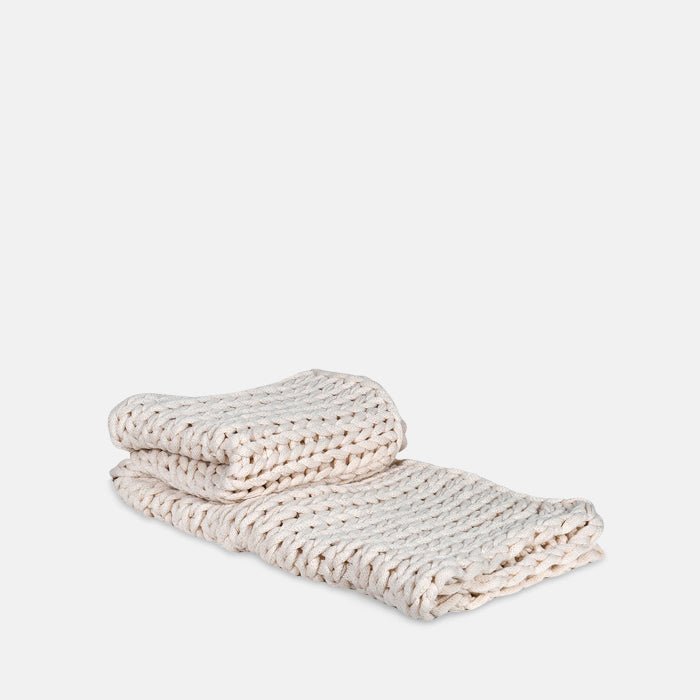 A cutout of the Baxley Chunky Knit Throw, a cream coloured chunky knit throw.