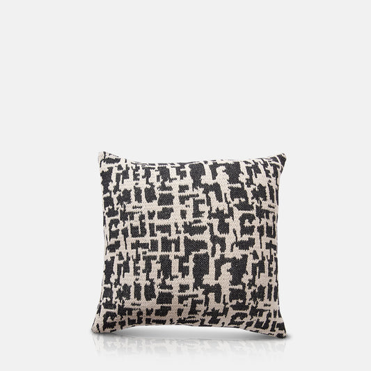 Woven monochrome square cushion with abstract pattern.