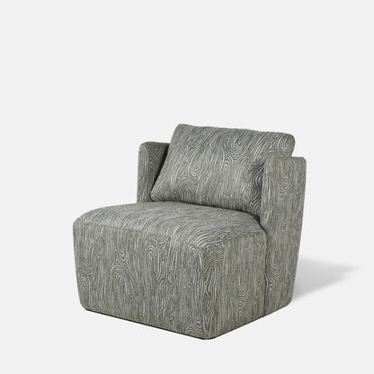 An upholstered grey armchair with a raised green wavy pattern.