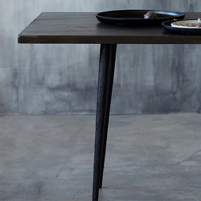 Rectangular wooden dining table with dark stained wood and black metal legs.