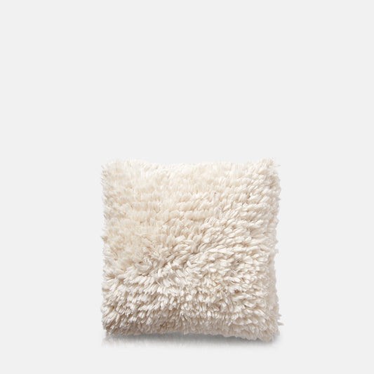 White tufted cotton cushion in square shape.