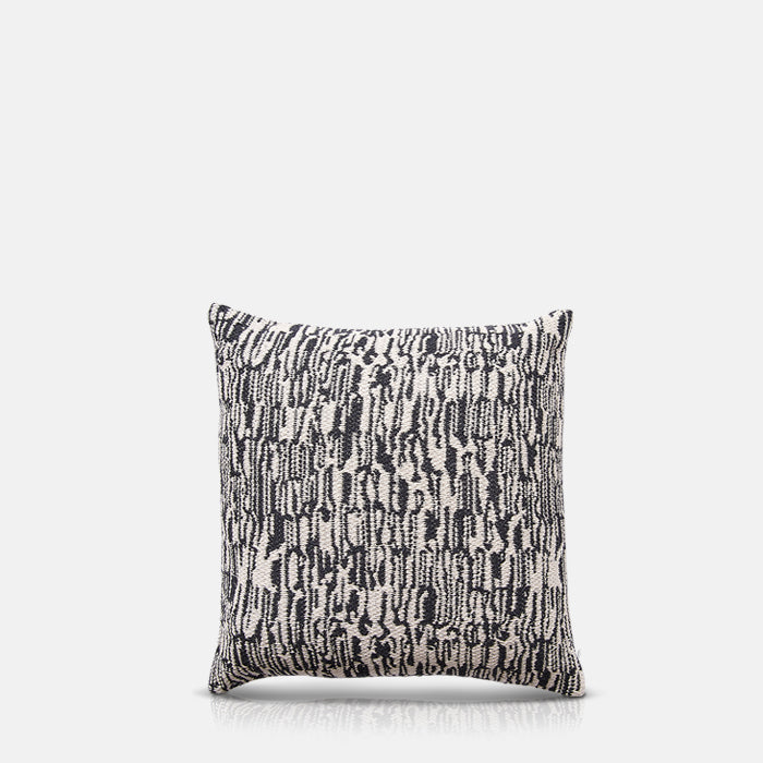 Square cushion in woven monochrome abstract design.