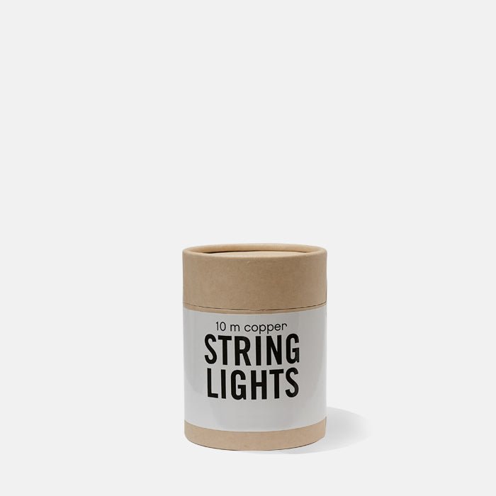 Brown, round box with copper string lights written on the front