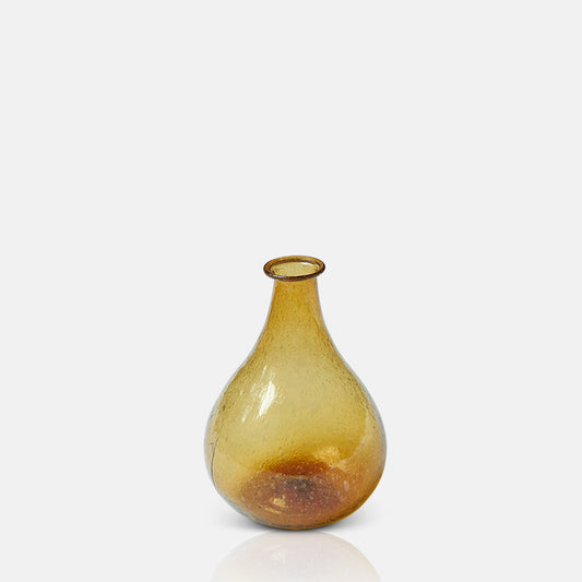 Amber glass bottle vase with organic rounded shape.