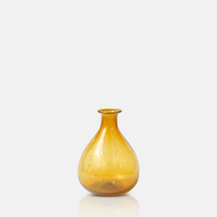 Small curved bottle vase in warm amber coloured glass.