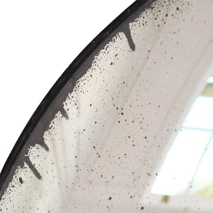 A closeup of the aged look glass on the edge of the Farah Convex Mirror.