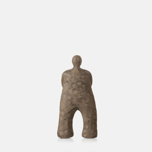 Polyresin sculpture of an abstract standing figure, finished in a rustic matte brown glaze.