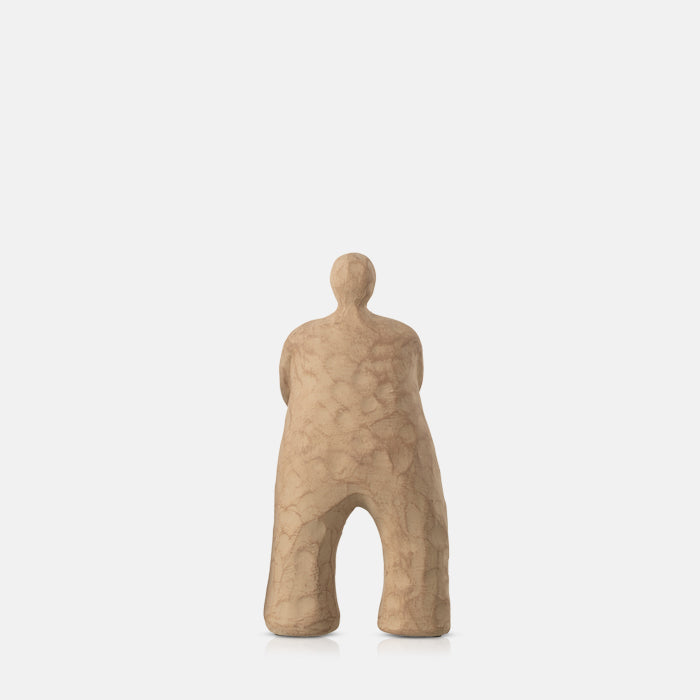 Polyresin sculpture of an abstract standing figure, finished in a sandy matte brown glaze.