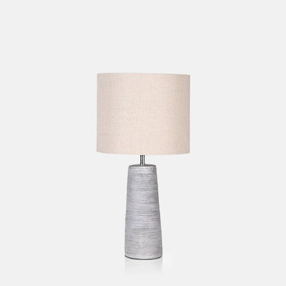 Table lamp with white-wash look base and cream drum shade.