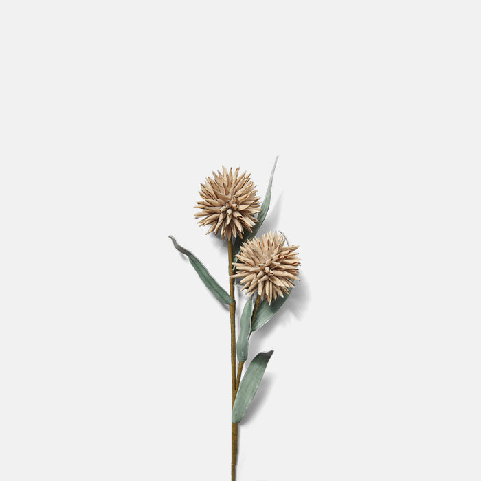 Brown paper-wrapped stem with two artificial globe thistle heads in peach, and grey-green leaves.