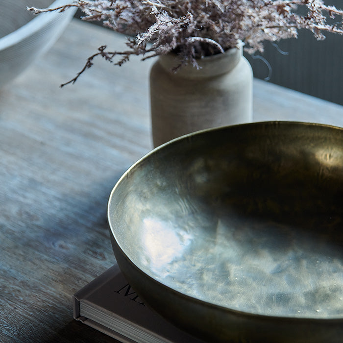 Shallow brass bowl with subtle hammered texture.