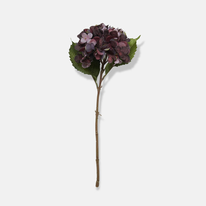 An artificial dark purple hydrangea flower with brown resin stem and two green leaves.