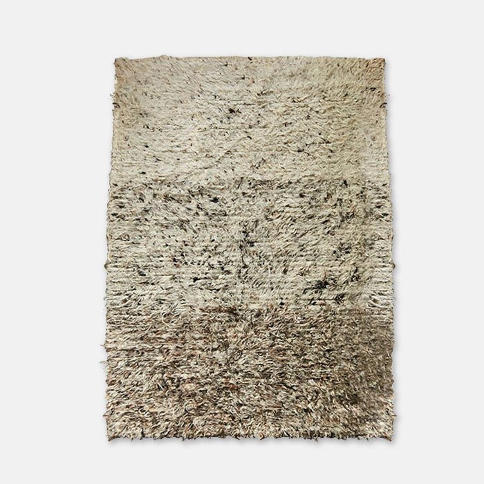 Shaggy wool rug in gradient of cream, brown and grey tones.