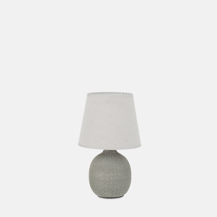 Small table lamp with textured grey base and simple white shade.