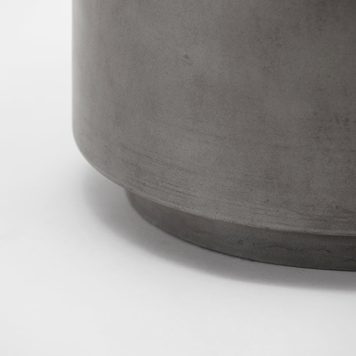 Grey concrete details on the curved surface of a side table