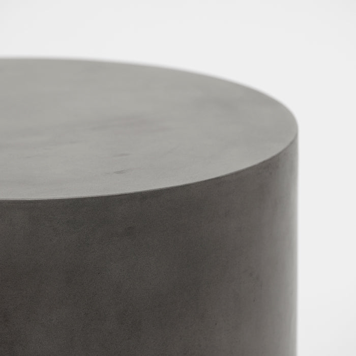 Smooth grey concrete side table in round shape.