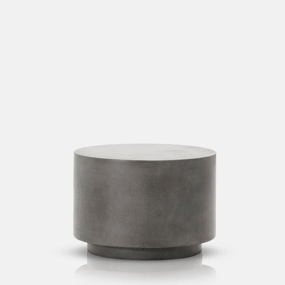 Round concrete side table with tiered base design.