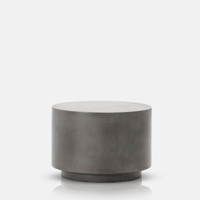A cutout of the Lander Side Table - Medium, a smooth cylindrical table made from grey concrete.