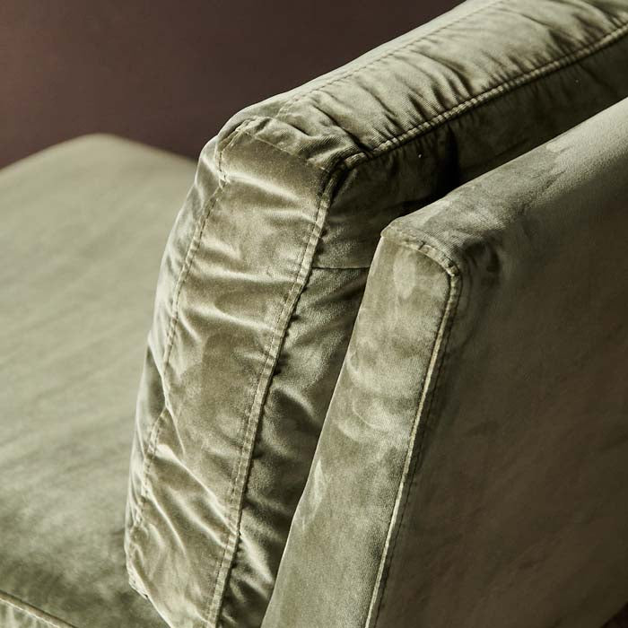 Olive green velvet upholstery on chair.