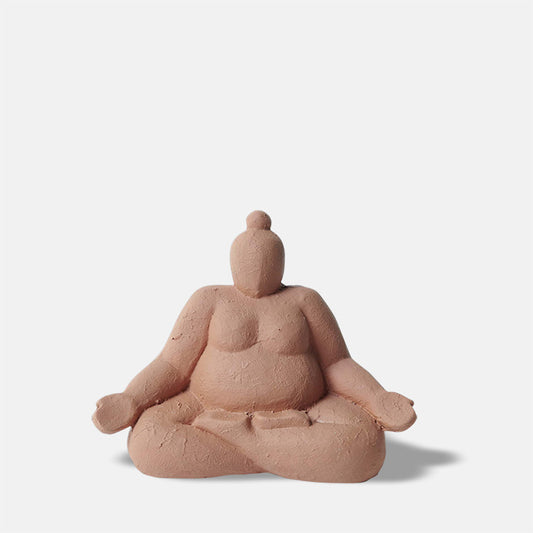 Orange coloured crossed legged meditating figure 