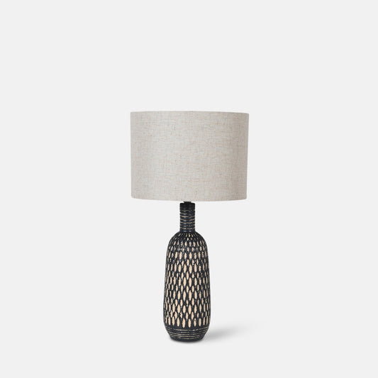 Tall black and white ceramic lamp base with a round cream shade