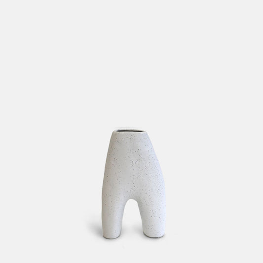 Arch shaped white ceramic vase with black speckles 