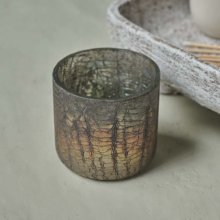 Crackled glass candle holder with aged metallic finish.