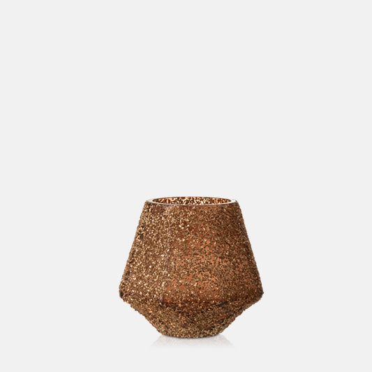 Warm brown glass candleholder in glitter finish and geometric shape.