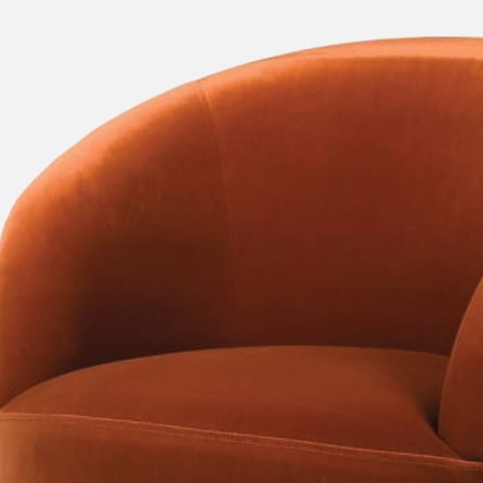 A closeup of the rich rust hued velvet upholstery of the Moore Rust Velvet Armchair.