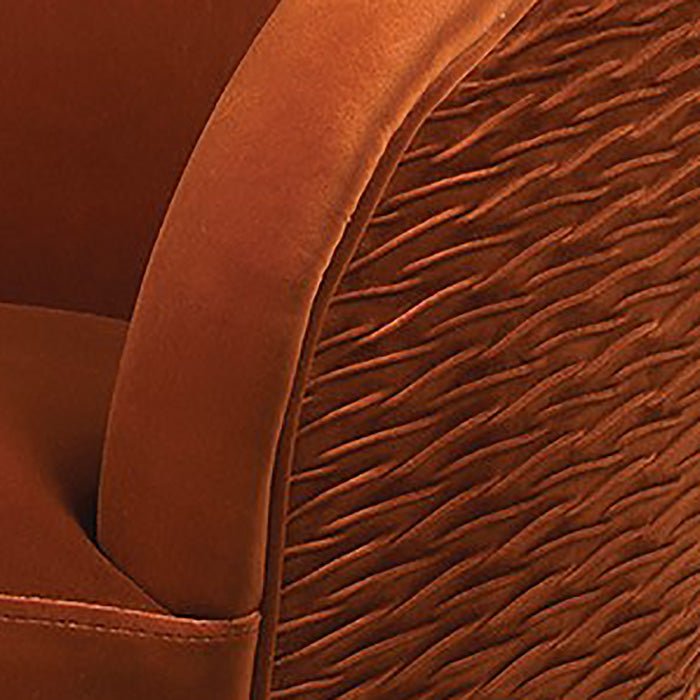A closeup of the pleated effect back section of the richly hued Moore Rust Velvet Armchair.