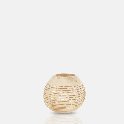Round coconut candle holder with horizontal line cut-out design.