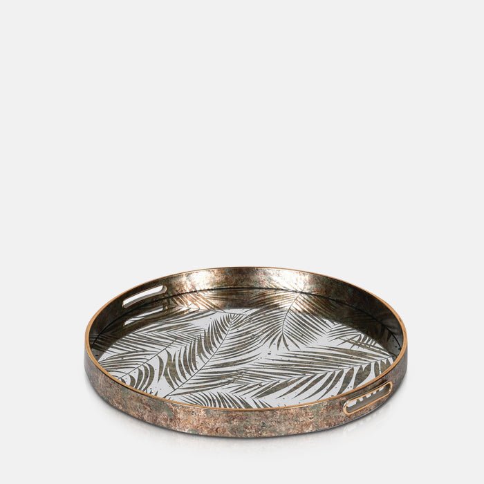 A cutout of the Nassua Tray, a round tray with a mirrored surface featuring a botanical design.