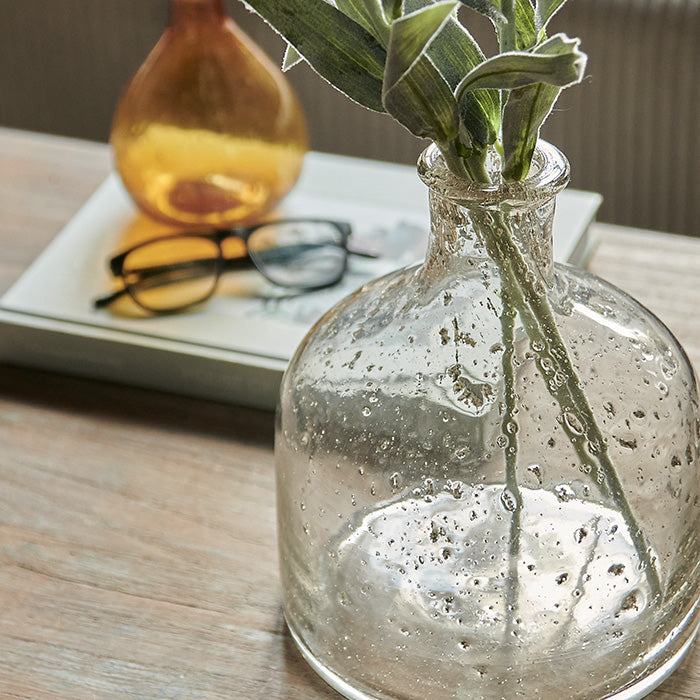 Recycled-look clear glass vase with bottle neck.