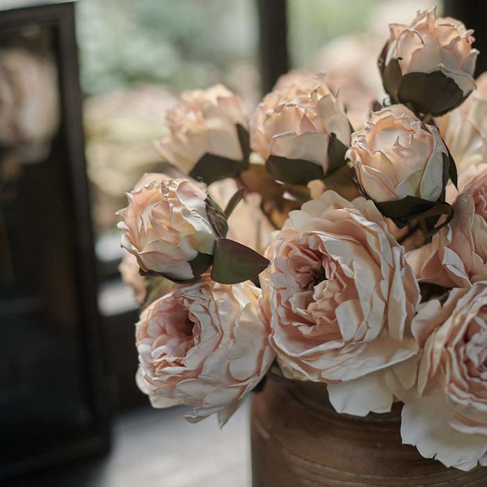 Artificial blush coloured peony flowers.