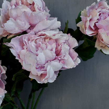 Artificial peony flowers in pale blush pink tones.