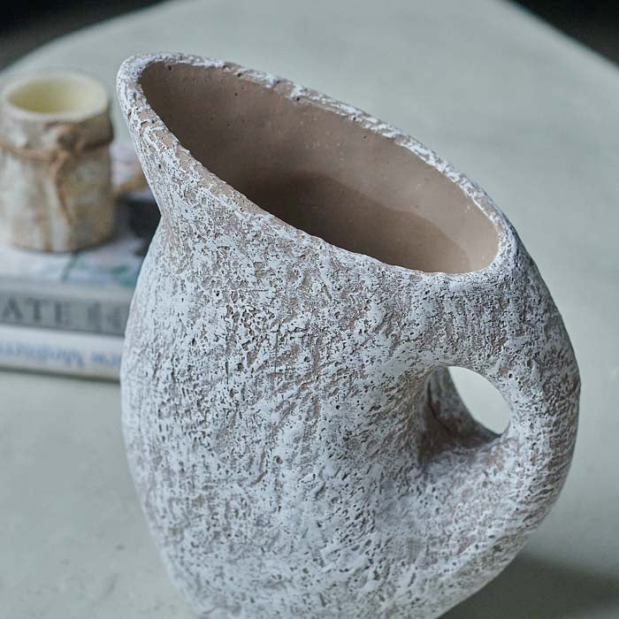 Textured white vase with a natural brown inside in a jug shape