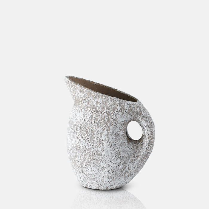 White jug shaped vase with a textured surface and curved handle