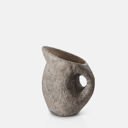 Jug shaped dark brown vase with a handle and textured surface