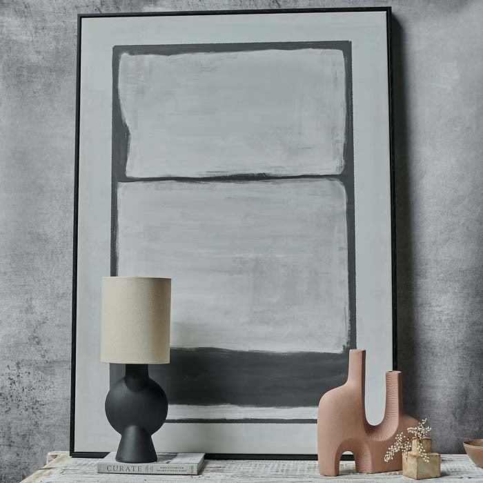 The Saxon Abstract Print, a large rectangular monochrome abstract print in a thin frame resting on a console table.