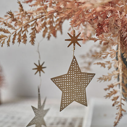 A set of delicate star decorations hanging from a tree.
