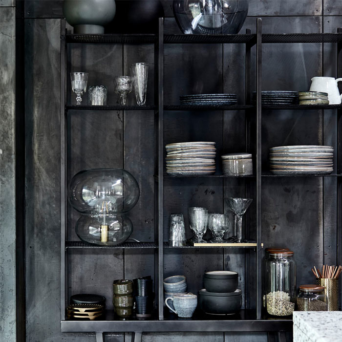 Kitchen accessories displayed on a large dark grey metal shelving unit.
