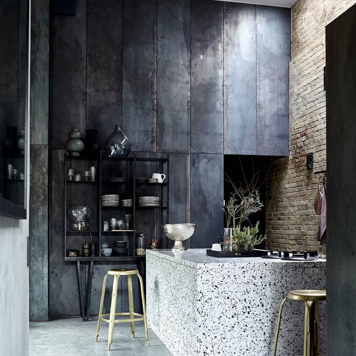 A large metal shelving unit in an industrial style kitchen.