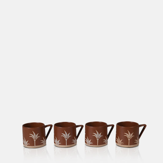 Set of four stoneware mugs with handles, finished in terracotta glaze with palm tree motif.