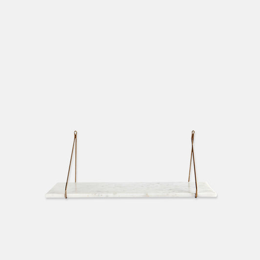 Long white marble shelf with two triangular shaped gold brackets at either end