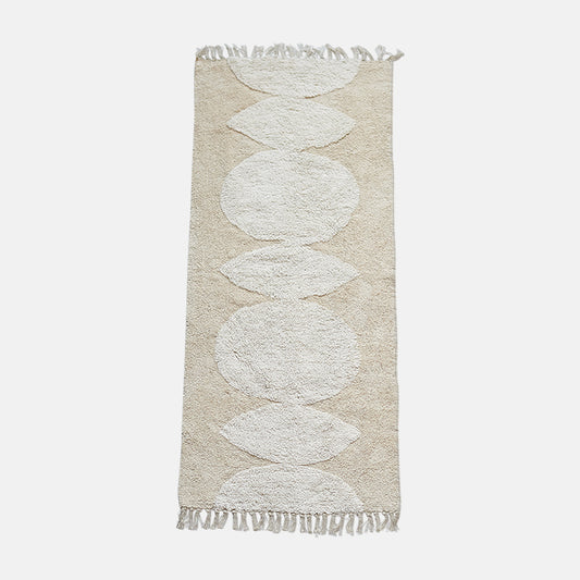 Cotton runner in natural beige and cream tones with abstract circle pattern design.